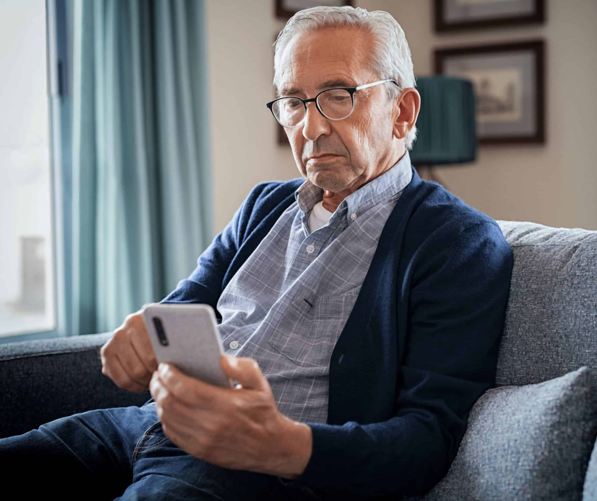 Older Adult holding a smartphone in hand